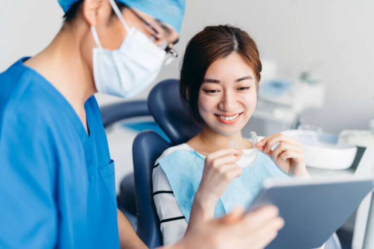 A young lady getting treatment by orthodontist