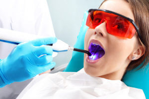 Emergency Dentist performing Dental check-up on a girl Patient