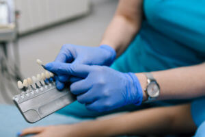 Dentist showing veneers to her patient