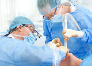 Surgeons placing implant