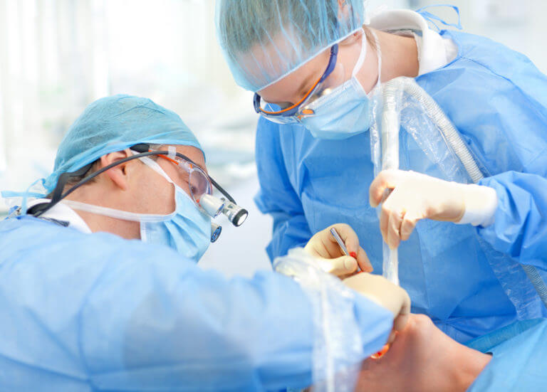 Surgeons placing implant