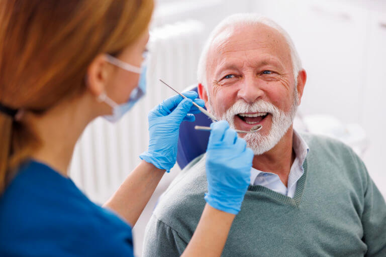 Shot of a young woman checking her results in the dentists office