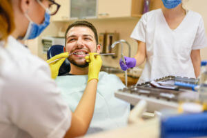 Man at the dentist braces check up