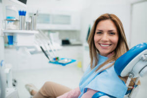 Happy woman visiting a dentist office