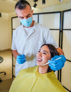 Woman is getting treatment in a dentist's office