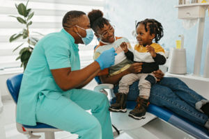 Family Dentist playing with his patients