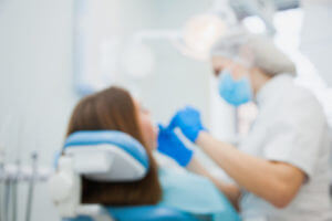 blurred image of emergency dentist with patient at clinic