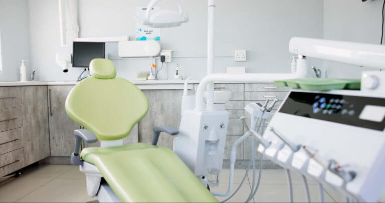 Empty dentist room, chair and equipment for cleaning, wellness and oral health in a Dentist Office.