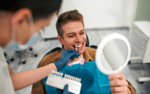 Image of a dentist providing dental teeth whitening services.
