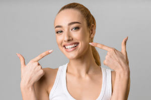 Happy lady showing her beaming white teeth.