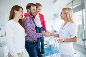 Family visits family dentist in dental office.